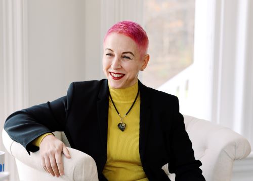 SEO rank your website with Gabriela Humailo Parker - a pink hair lady smiling with all face